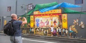 Tourist taking photo of the Cantonese Opera mural